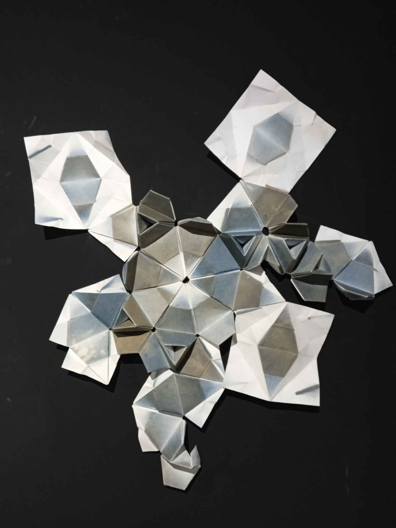 30 Memories of Porto; an origami sculpture with geometric forms printed onto 30 sheets of paper in shades of blue-gray and blue-green